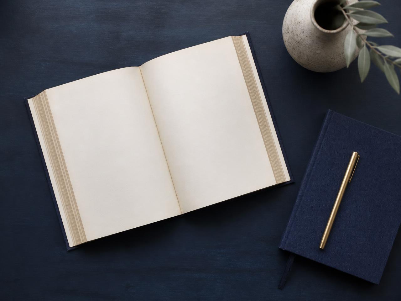 An open book and a notebook on a desk